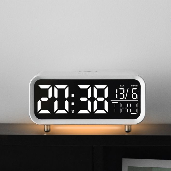 Top view of multifunctional alarm clock showing control buttons and LED display with alarm settings